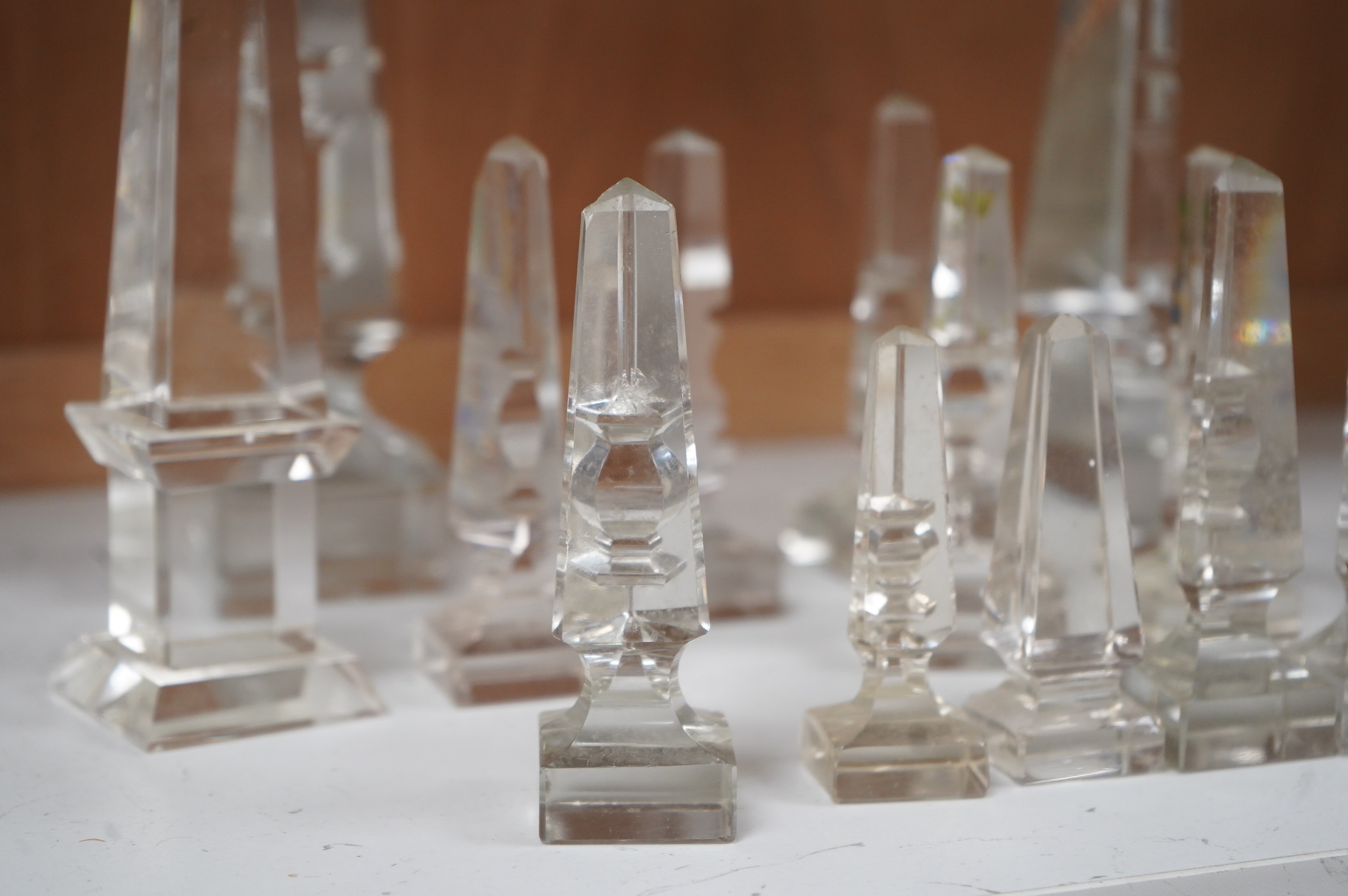 Twelve Victorian glass deceptive obelisks, and two later glass obelisk ornaments, largest pair 21cm high